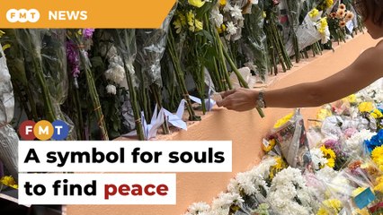 At memorial site, 12 origami birds as symbol of souls finding peace