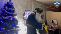 Soldiers wearing festive costumes give gifts to children on Ukraine's frontline