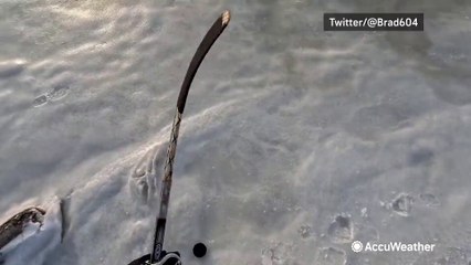 Showing off hockey skills over frozen ocean waters