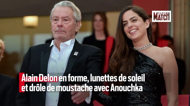 Alain Delon en forme, lunettes de soleil et drôle de moustache avec Anouchka