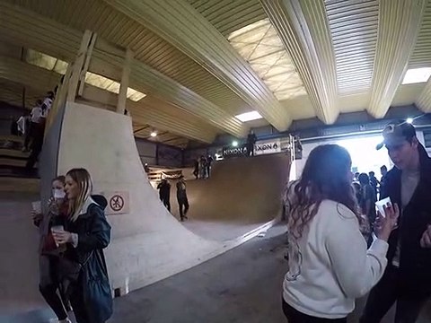 Skateboarder drops into half pipe and lands on back of head