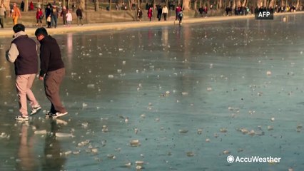 Visitors walk on frozen Lincoln Memorial Reflecting Pool