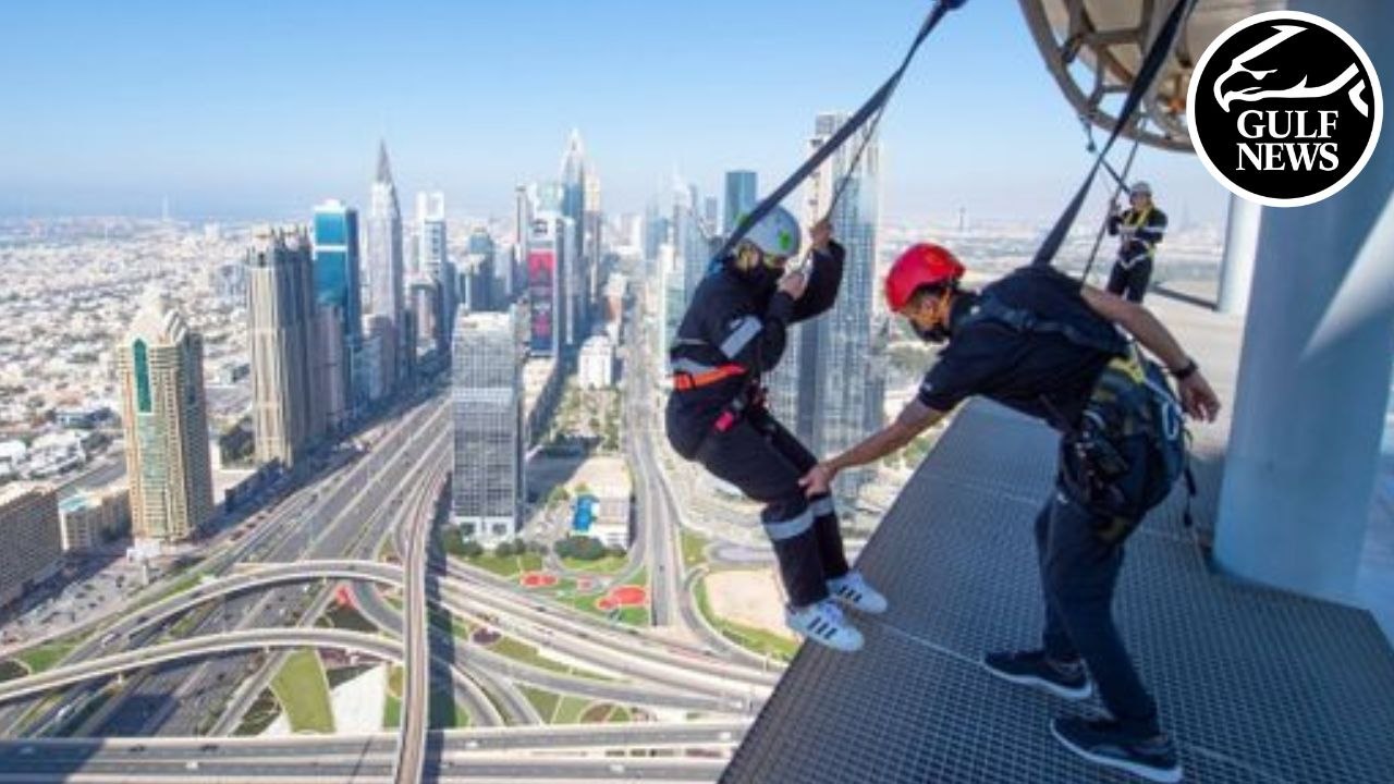 Walking along the edge of Sky Views Dubai | Glass slide | Sky Views Observatory