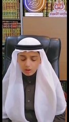 A arabian boy is reading the Qur'an