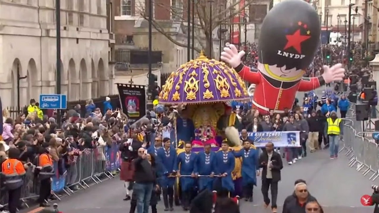 Giant inflatable Queen’s guard floats through London for New Year’s Day parade
