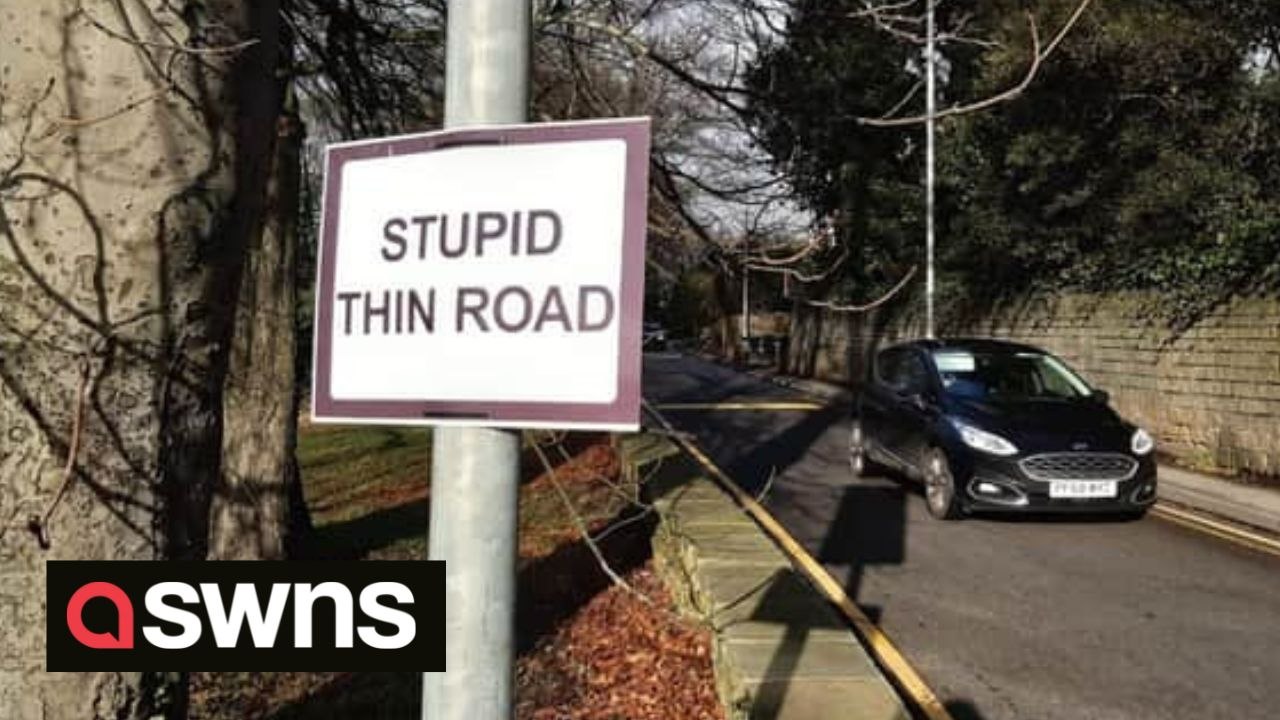 Angry locals have put up their own sign warning of a 'stupid thin road' after constant jams, beeping and crashes