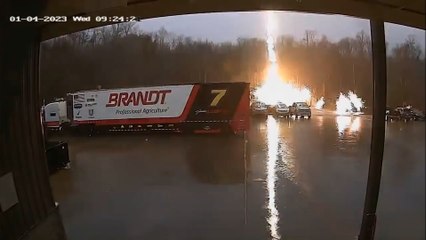 Four CCTV cameras capture stray lightning bolt striking parked truck - sending sparks and smoke across a parking lot