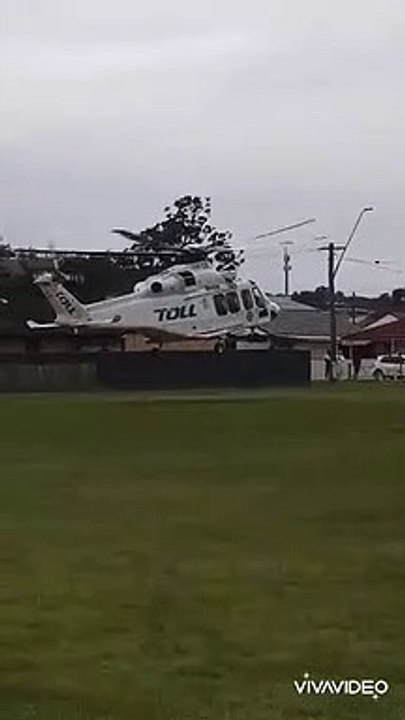 Toll rescue helicopter flying to Liverpool hospital after a crash at Unanderra. Video by Dan Rowlands.