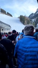 Crowd Cheers for Skier Coming Down Slope