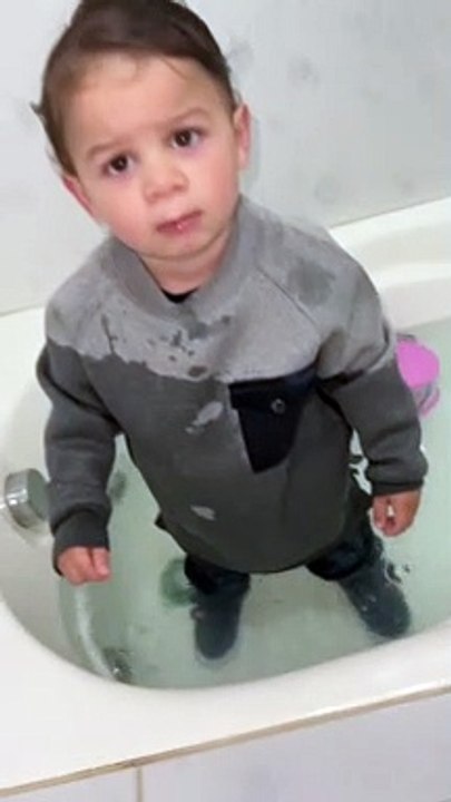 Toddler Climbs into Bathwater Fully Clothed