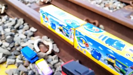 playing tayo cars on the edge of the railroad