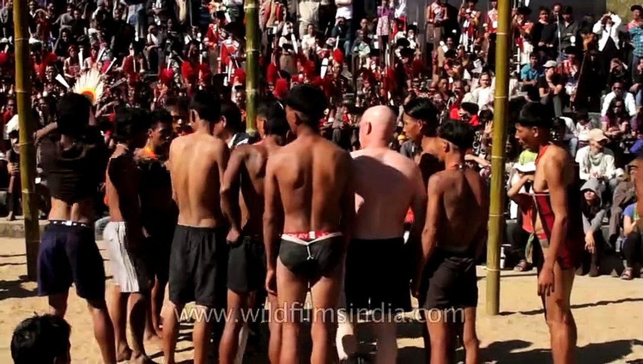 American participating in the greased pole climbing competition, Hornbill Festival