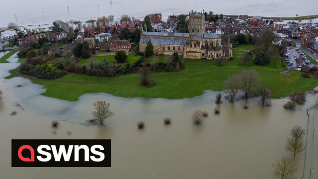 Tewkesbury Abbey turned into an island as flood water streams off the Malverns
