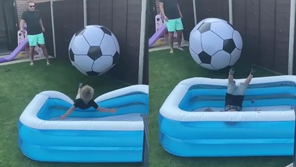 Dad knocks son into pool by kicking a GIANT football his way