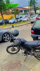 Train of Toy Cars Pulled Down the Street by Cyclist
