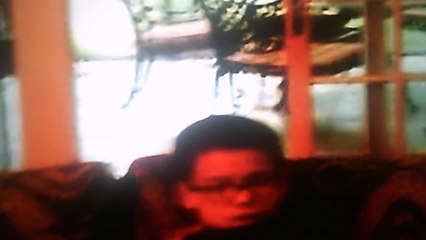 Jonathan playing his kindle while Anthony watches spongebob