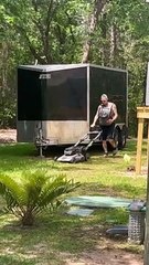 Man Mows Lawn While Carrying Cat in Backpack