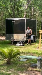 Man Mows Lawn While Carrying Cat in Backpack
