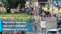 Desesperados, migrantes dan portazo e intentan ingresar a la fuerza a Estados Unidos