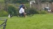 Woman riding son's bicycle in the lawn falls on her side *Hilarious Fail*