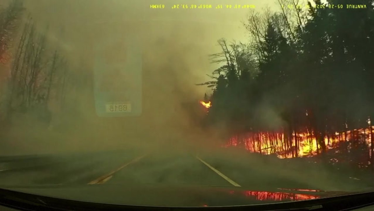 Dashcam footage shows car driving straight through Canadian wildfire