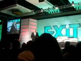 Exit Realty. Convention. Steve Morris talking about hammers?