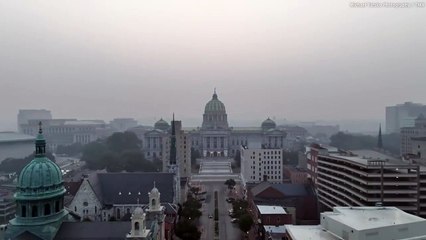 Drone footage shows Harrisburg, PA skyline obscured by a smoky haze
