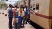 Social workers run with water as soon as the passenger train stops