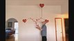 Person Juggles Three Balls While Balancing Stick With Animated Heart From Their Chin