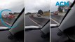 Car driving wrong way on busy highway causes near miss