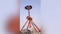 China: Terrifying moment tourists are left hanging upside-down on broken amusement park ride