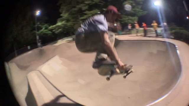 Skateboarder ollies over spine of bowl and lands on his ankle