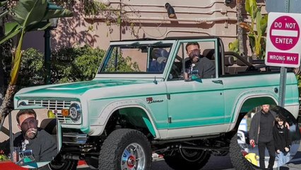 Ben Affleck puffs on a cigarette while driving his $1.9m vintage Ford Bronco.