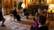 King and Camilla meet Holocaust survivors and light candle