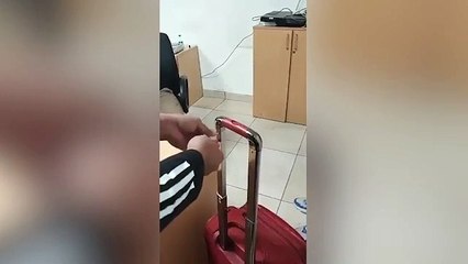 Airport officials found the equivalent of £63,372 in cash stashed inside a SUITCASE HANDLE