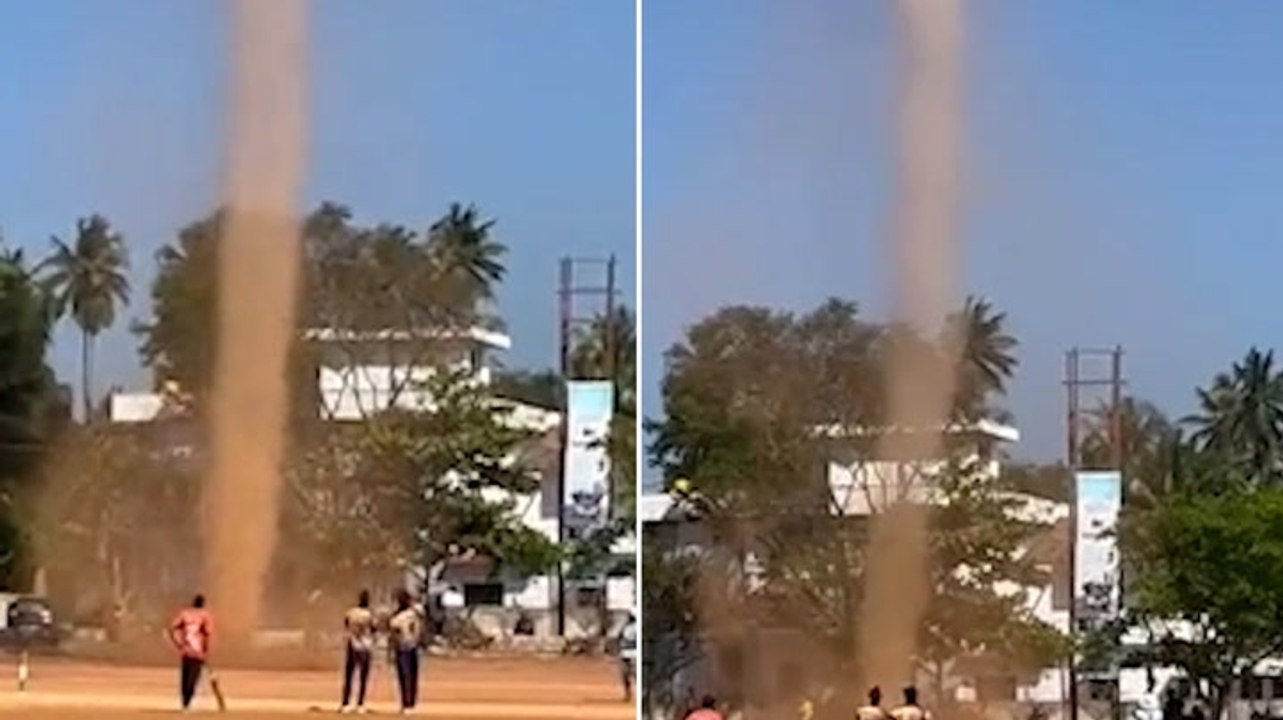 Towering whirlwind spins across field as witnes...