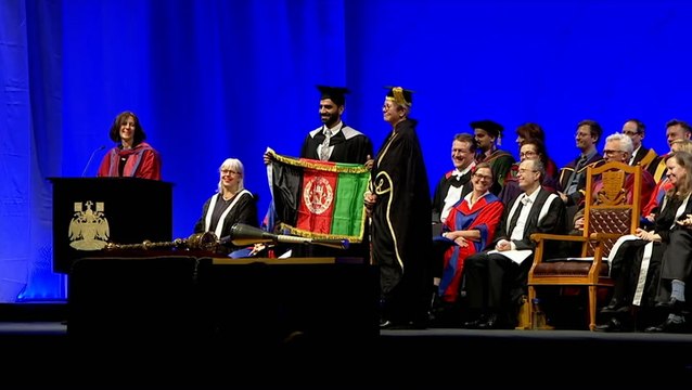 Refugee who fled Taliban holds Afghan flag as he graduates at UK university