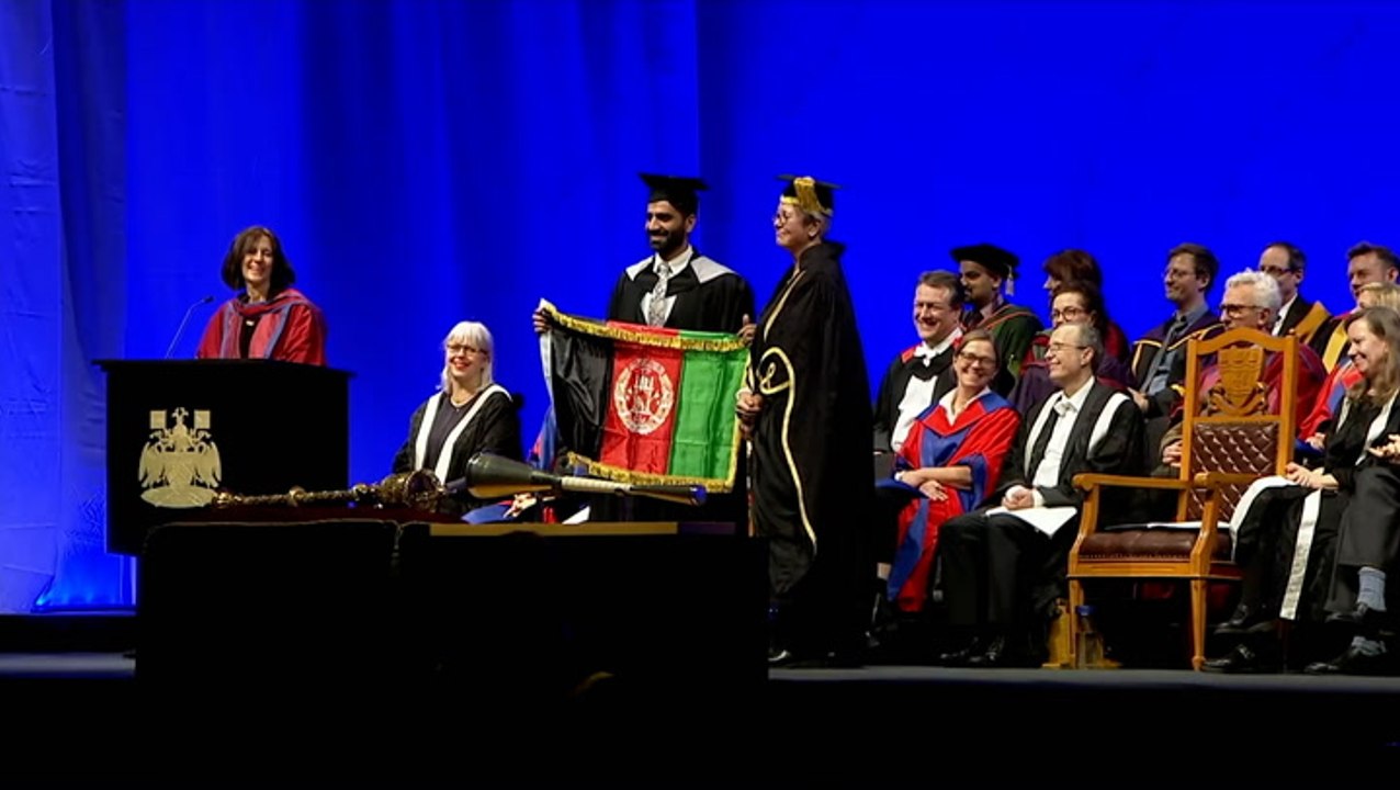 Refugee who fled Taliban holds Afghan flag as he graduates at UK university