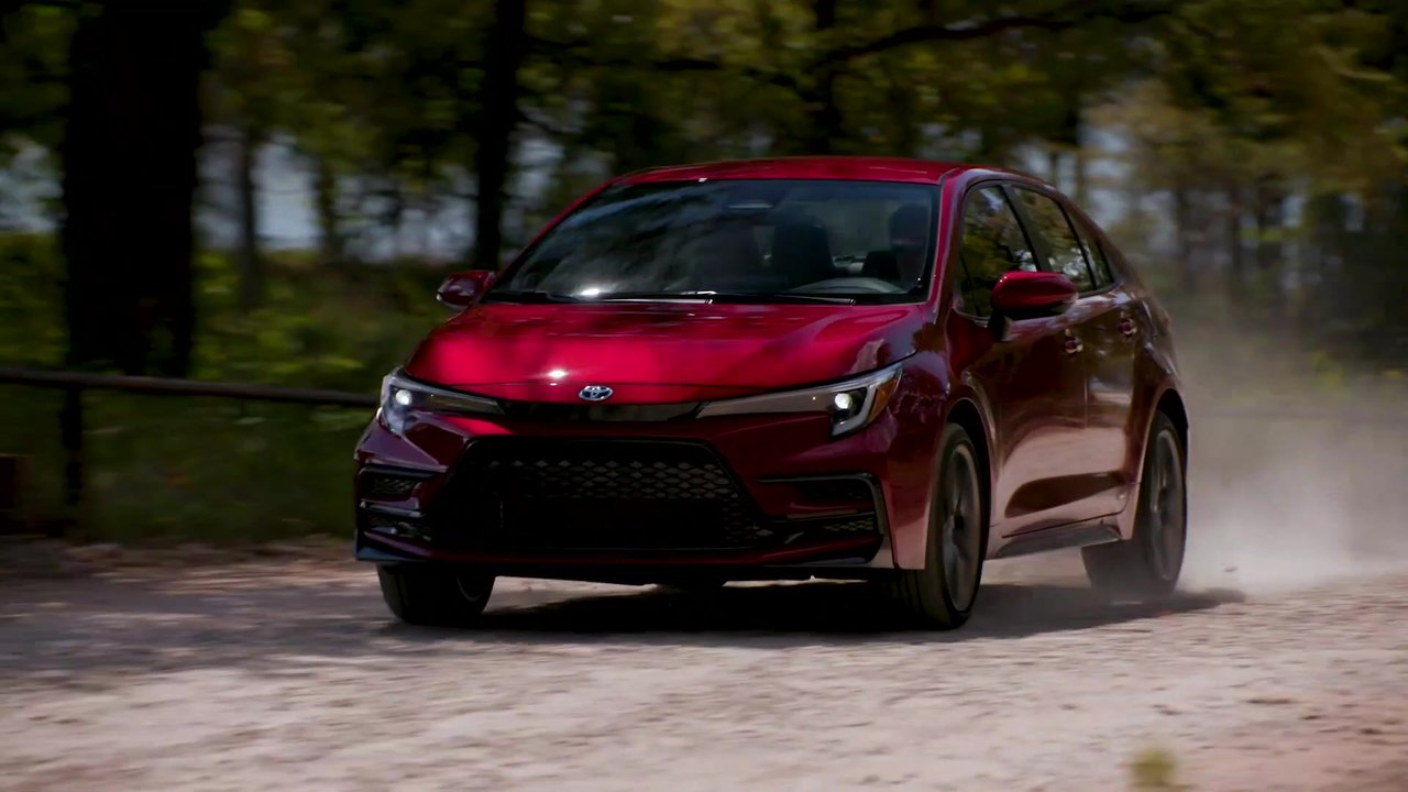 2023 Toyota Corolla SE Hybrid in Ruby Flare Pearl Car Driving in the country