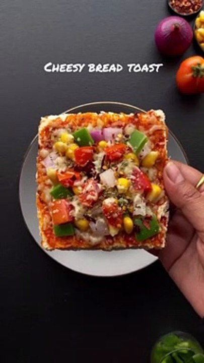 Cheesy bread toast recipe--_Do try it and save for later☺️❤️_Ingredients for cheese bread toast recipe__Bread slices _Grated mozzarella cheese 1_2 cup _Pizza sauce 1 tbsp _Onion 1_2 _Capsicum 1_2 _Sweet corn 1_4 cup _Tomato 1_2 _Butt(