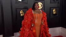 Watch: Lizzo stuns in orange floral cape on Grammys red carpet
