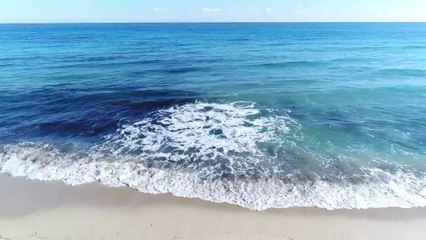 mixkit-waves-coming-to-the-beach-5016-medium