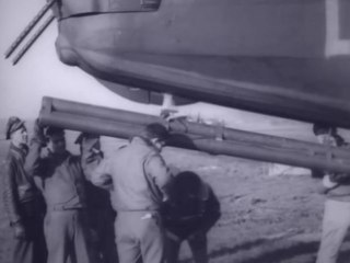 USAAF 489th Bomb Group B-24 being fitted with tail rocket launcher, Hethel, England  15 Dec 1944