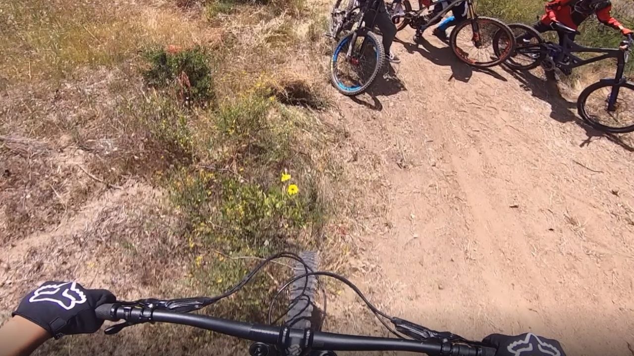 Squad Goals ! MTB rider tries to avoid collision with fellow riders; trips over a rock instead
