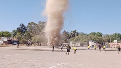 Messy Dust Devil emerges during a street football game