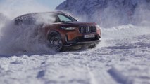 BMW X1 23d 2023 in Utah Orange Metallic, drifting on ice