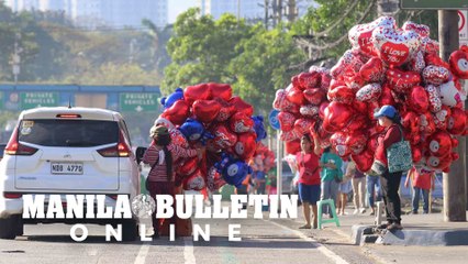 Vendors sell Valentine-themed balloons along Katipunan Ave