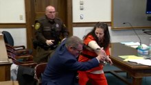 Moment woman accused of decapitating lover attacks her own lawyer in court