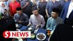 Anwar stops for chicken rice at Sepang stall before Friday prayers