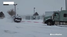 Semi truck pulled out of snowy hill in Wyoming